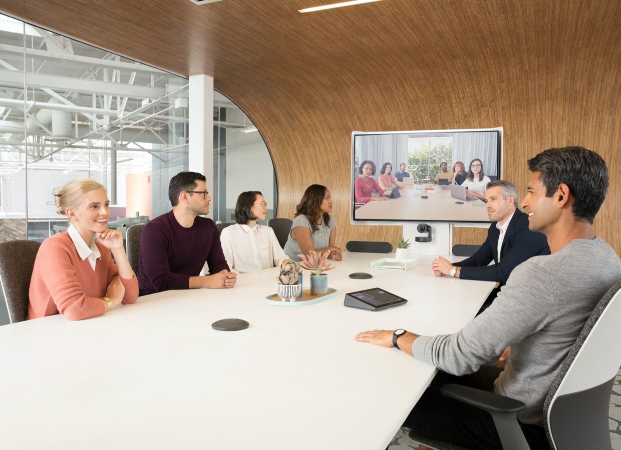 People in meeting with HP systems and Logitech Tap Large Room solutions