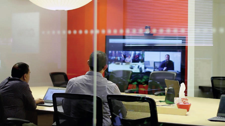 People around video conference table