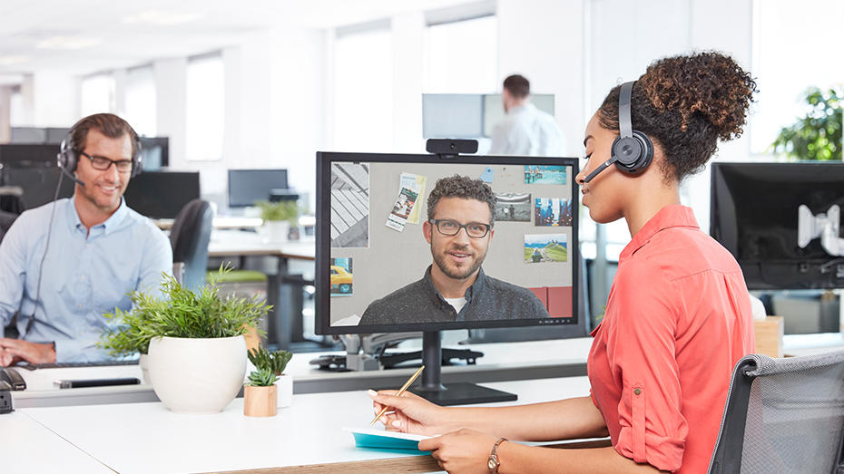 Woman working in office and video conferencing with wireless headset